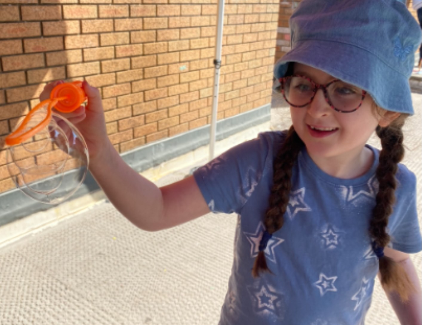 Girl playing with bubbles outdoors
