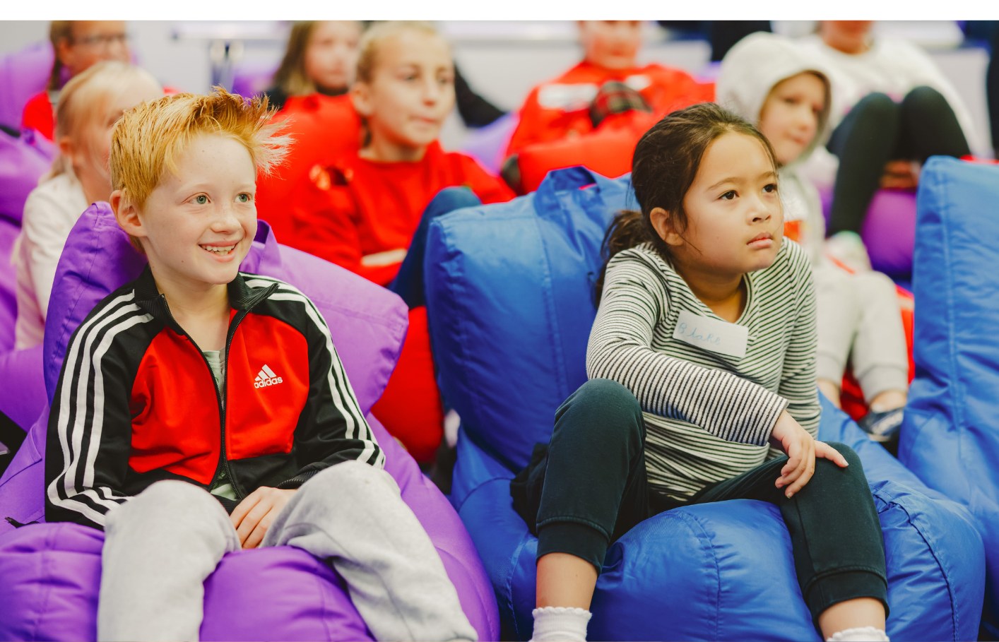 Children watching a film on beanbags in the studio cinema
